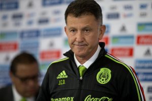 Juan Carlos Osorio, newly-appointed head coach of Mexico's national soccer team, wears his team jacket after being presented with it, at a press conference in Mexico City, Wednesday, Oct. 14, 2015. (AP Photo/Rebecca Blackwell)
